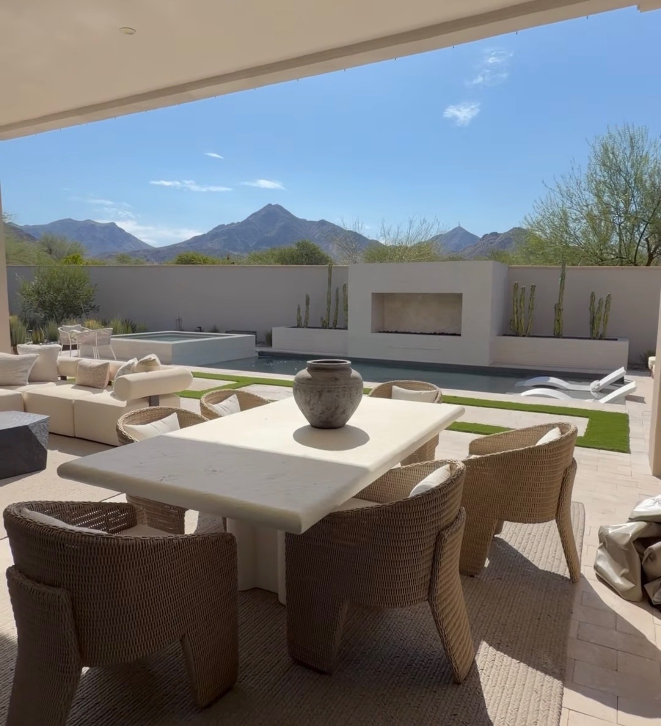 Covered modern Arizona patio with outdoor dining, pool and desert mountains